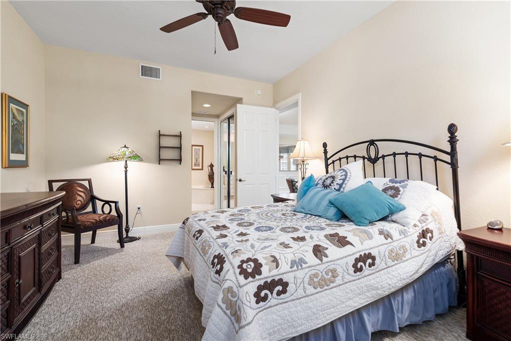 7837 Hawthorne Drive, Unit 1101 Naples, FL 34113 - Photo 12 of 26 a bedroom with a bed and wooden floor