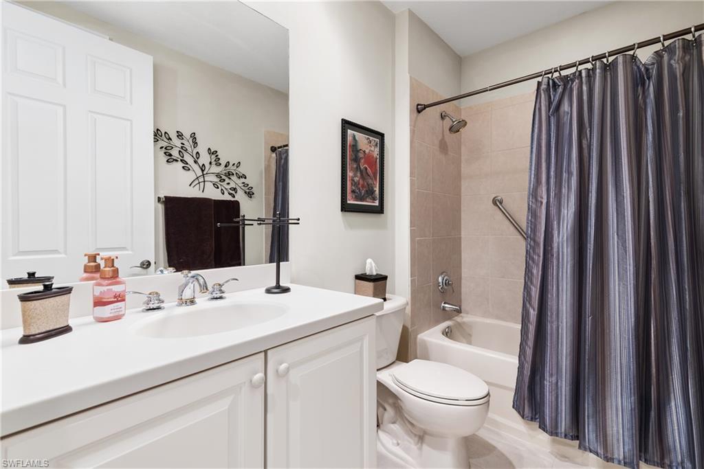 7837 Hawthorne Drive, Unit 1101 Naples, FL 34113 - Photo 16 of 26 a bathroom with a sink toilet and shower