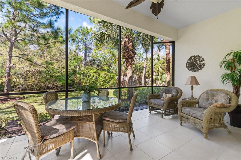 7837 Hawthorne Drive, Unit 1101 Naples, FL 34113 - Photo 18 of 26 a balcony with table and chairs