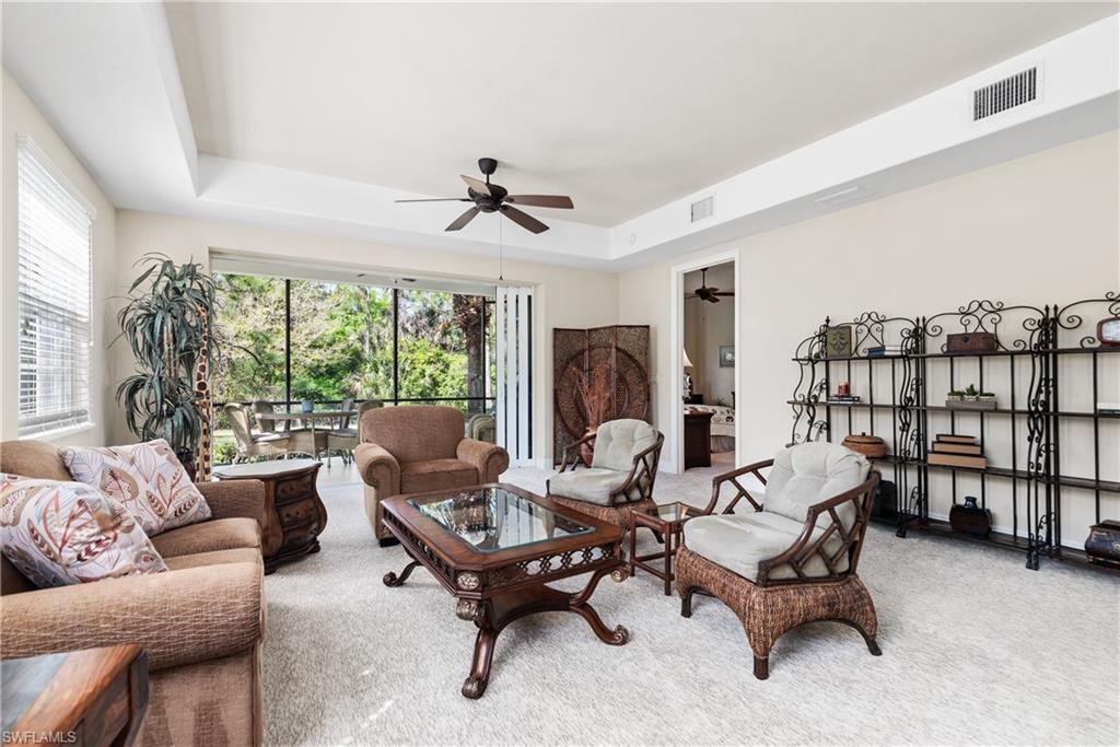 7837 Hawthorne Drive, Unit 1101 Naples, FL 34113 - Photo 4 of 26 a living room with furniture and a large window