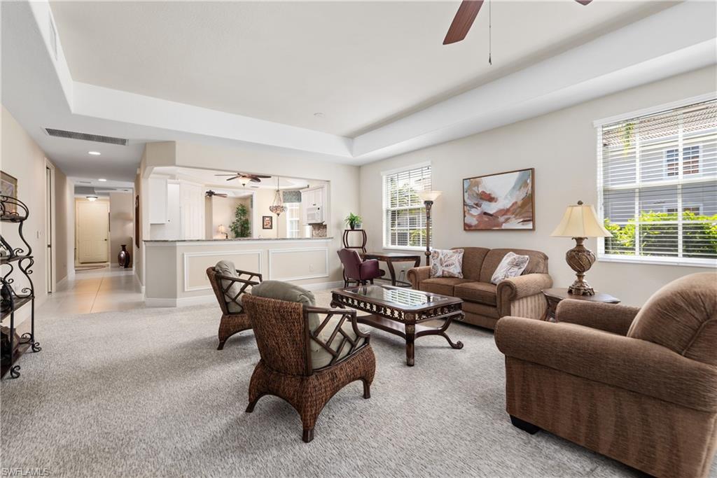 7837 Hawthorne Drive, Unit 1101 Naples, FL 34113 - Photo 5 of 26 a living room with furniture and a large window