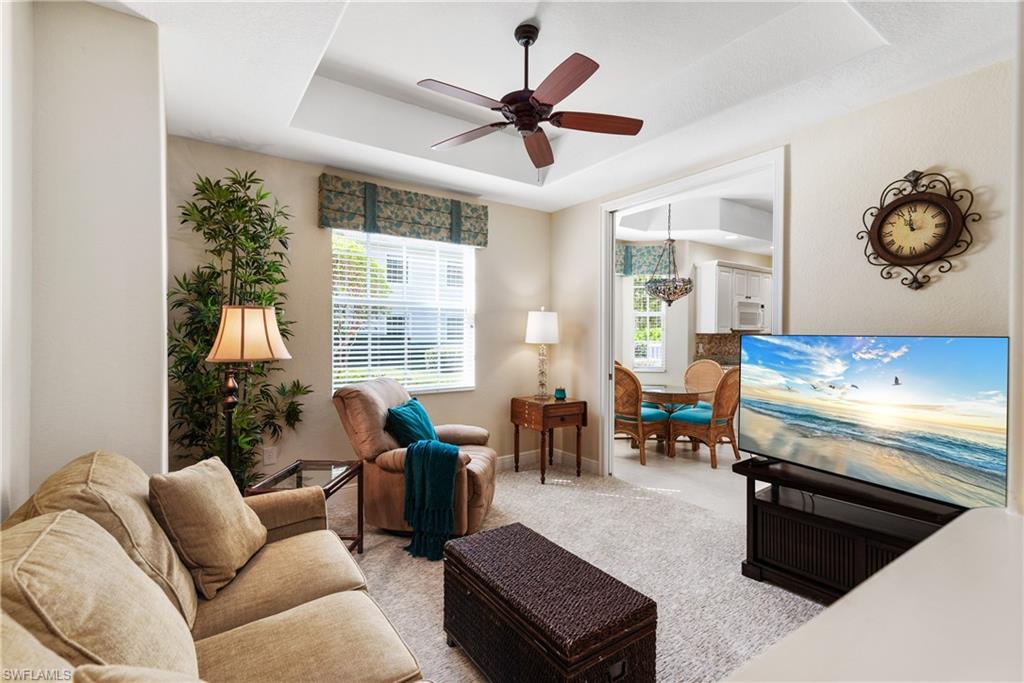 7837 Hawthorne Drive, Unit 1101 Naples, FL 34113 - Photo 9 of 26 a living room with furniture and a large window