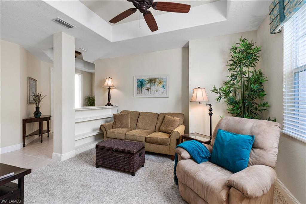7837 Hawthorne Drive, Unit 1101 Naples, FL 34113 - Photo 10 of 26 a living room with furniture and a potted plant
