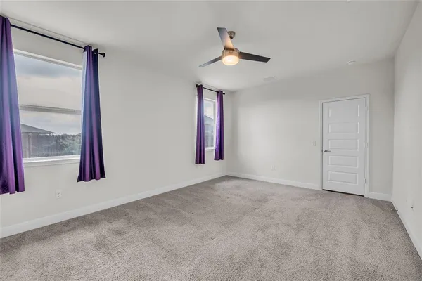 an empty room with windows and closet