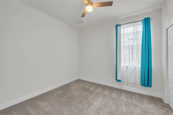 an empty room with windows and closet