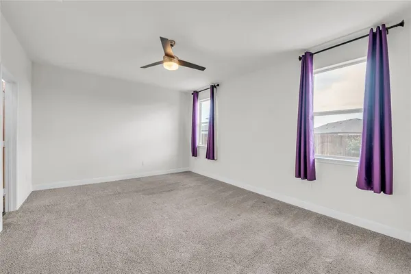 an empty room with windows and closet