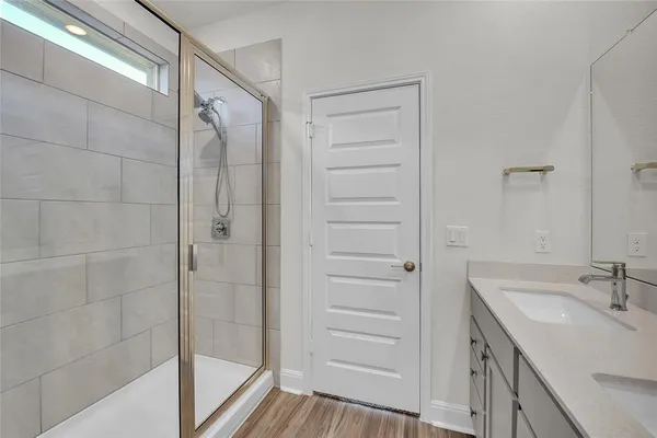 a bathroom with a shower and a sink