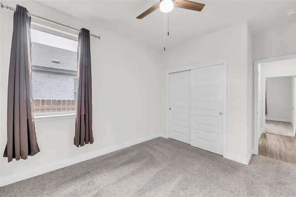 an empty room with a empty space and chandelier fan