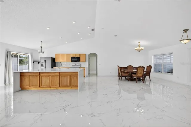 a kitchen with furniture and a refrigerator