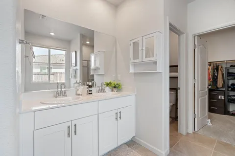 a bathroom with a bathtub sink and mirror