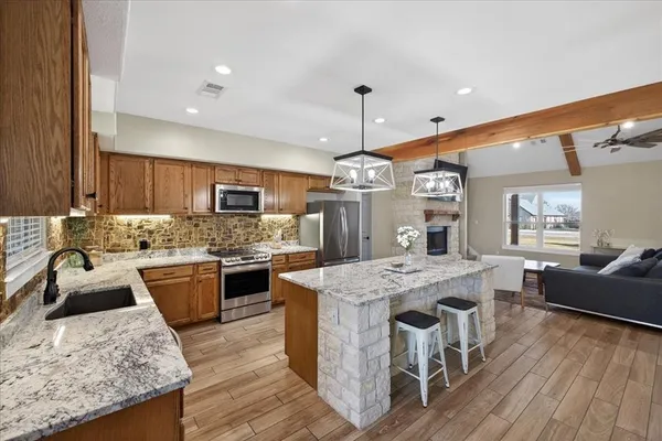 a large kitchen with kitchen island a island in the center