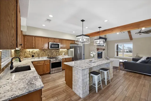 a large kitchen with kitchen island a island in the center