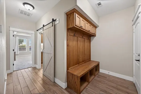 a view of hallway with wooden floor