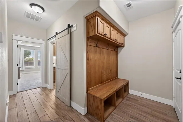 a view of hallway with wooden floor