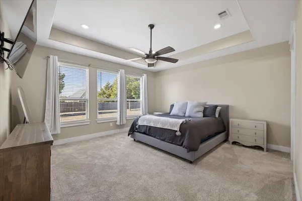 a spacious bedroom with a bed and a couch