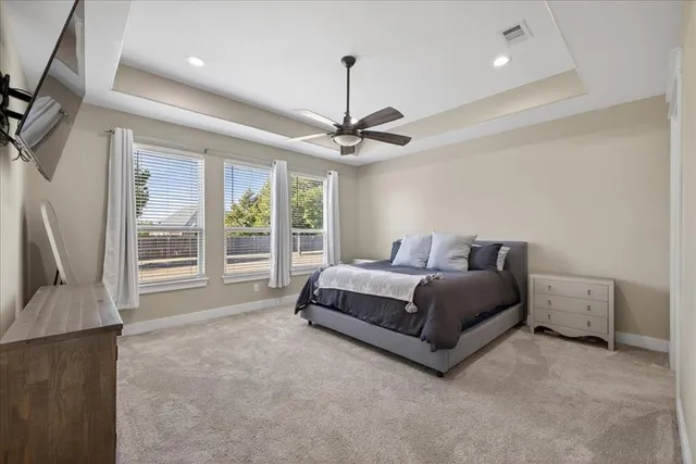 a spacious bedroom with a bed and a couch