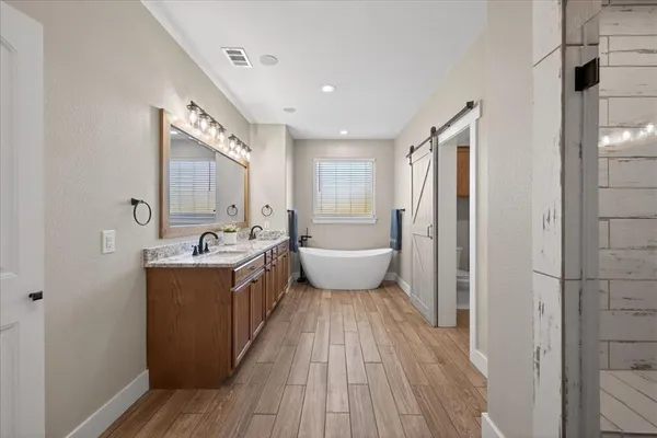 a spacious bathroom with a double vanity sink and a mirror