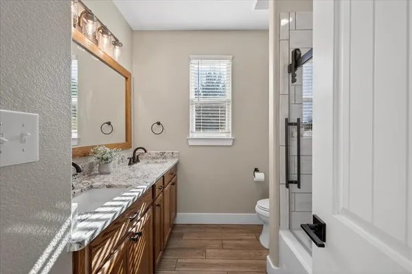 a bathroom with a sink a toilet and a mirror