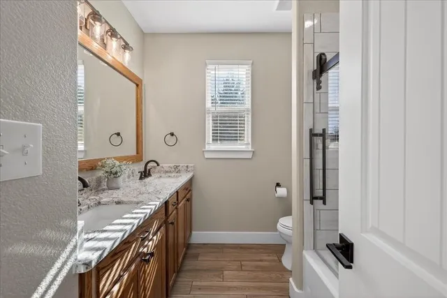 a bathroom with a sink a toilet and a mirror
