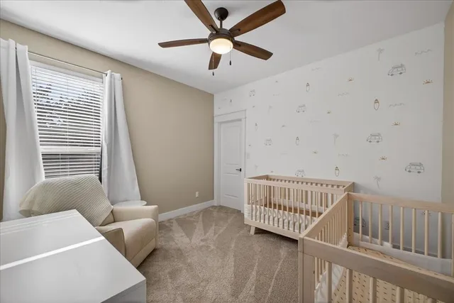 a view of a bedroom with furniture and a window