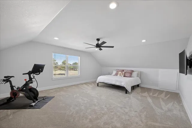 a living room with furniture and a gym cycle