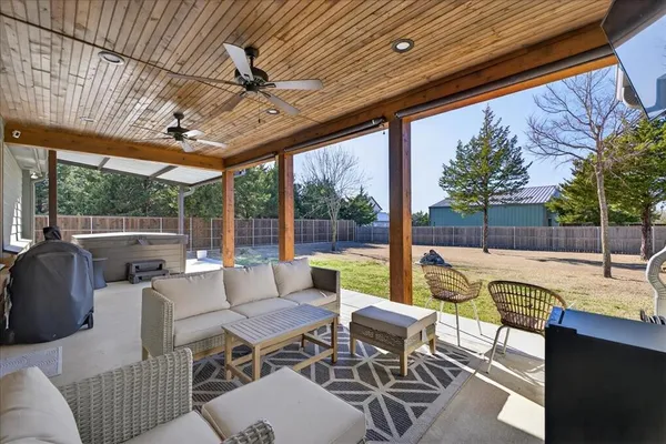 a building outdoor space with patio furniture and potted plants