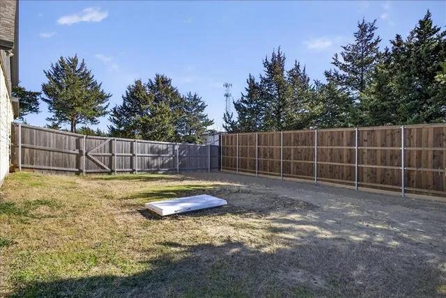 a view of backyard with small cabin