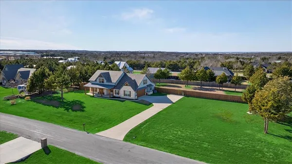 an aerial view of a house with a garden and trees