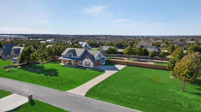 an aerial view of a house with a garden and trees