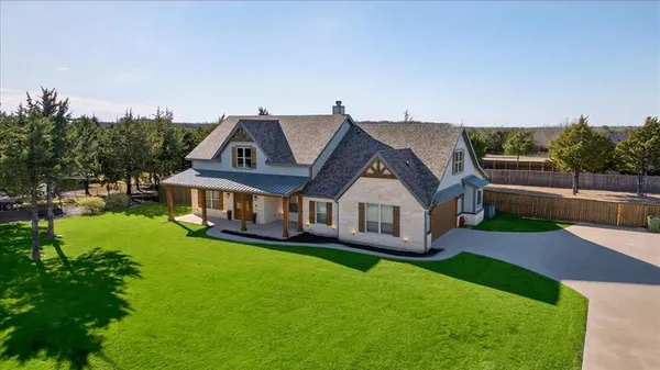 an aerial view of a house with a big yard