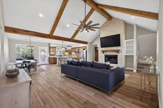 a living room with furniture a fireplace and a flat screen tv