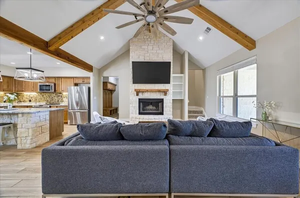 a living room with fireplace furniture and a flat screen tv