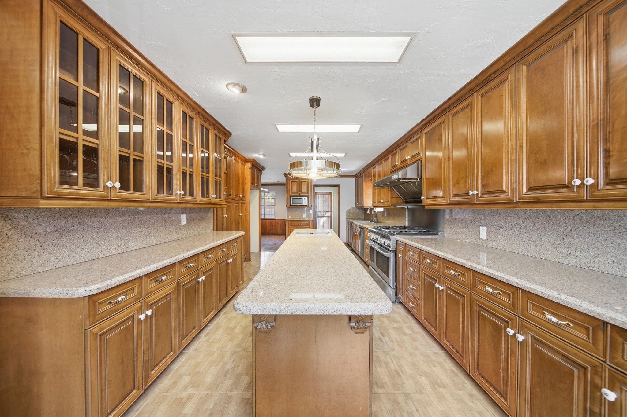 16806 Deep Pines Drive Spring, TX 77379 - Photo 12 of 18 a large kitchen with stainless steel appliances granite countertop lots of counter top space and wooden floor