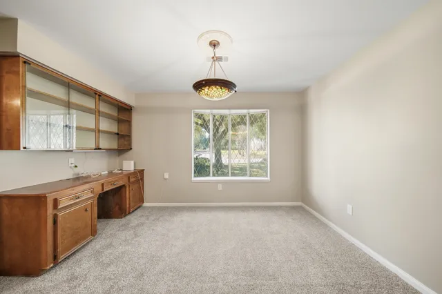 a large kitchen with a window and stainless steel appliances