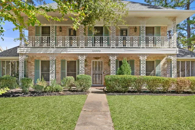 front view of a brick house with a yard
