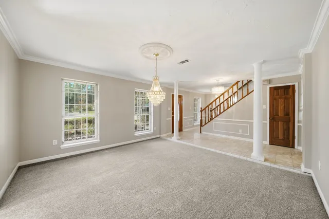 a view of an empty room with stairs