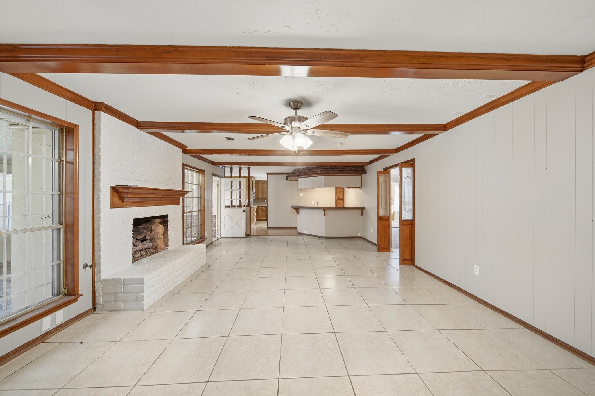 16806 Deep Pines Drive Spring, TX 77379 - Photo 7 of 18 a view of a livingroom with a fireplace a chandelier fan and windows