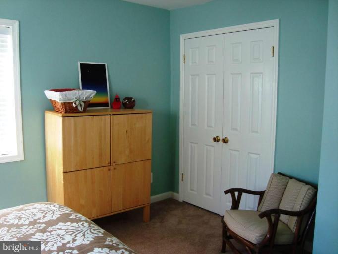 11 Hillcrest Road Riva, MD 21140 - Photo 22 of 28 a hallway with a bed and a mirror