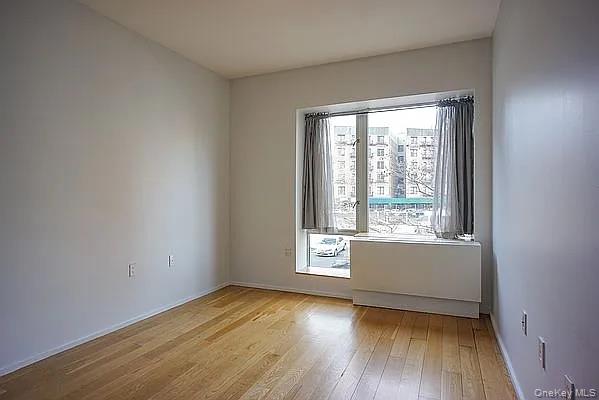 2280 Frederick Douglass Boulevard Manhattan, NY 10027 - Photo 5 of 16 Spare room featuring light wood-type flooring and baseboards