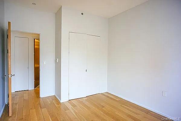 2280 Frederick Douglass Boulevard Manhattan, NY 10027 - Photo 6 of 16 Unfurnished bedroom featuring a closet and light wood-type flooring