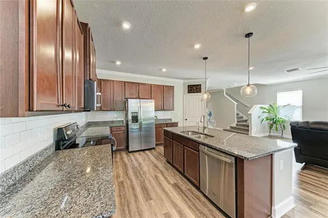 a kitchen with a stove a sink and a microwave