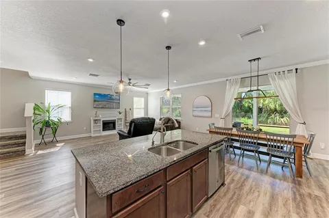 a living room with stainless steel appliances kitchen island granite countertop furniture and a kitchen view