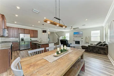 a living room with furniture and kitchen view