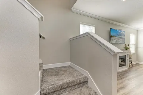 a spacious bedroom with a bed and a flat screen tv