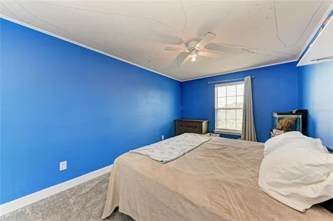 a bedroom with a bed and window