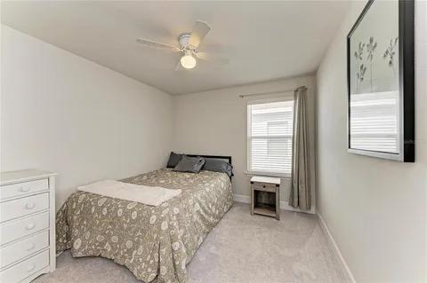 an empty room with windows and ceiling fan