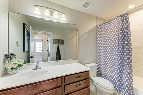 a bedroom with a bed window and a flat screen tv