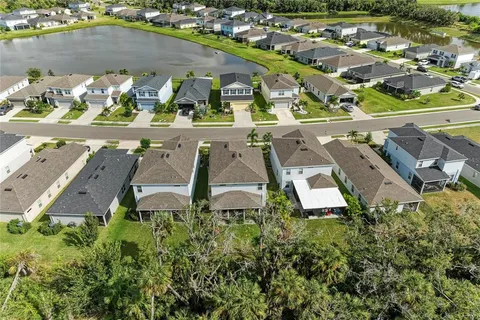 an aerial view of residential houses with outdoor space
