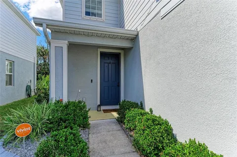 a view of a backyard with potted plants and a table and chairs