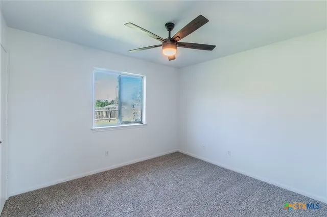 a view of an empty room with a fan